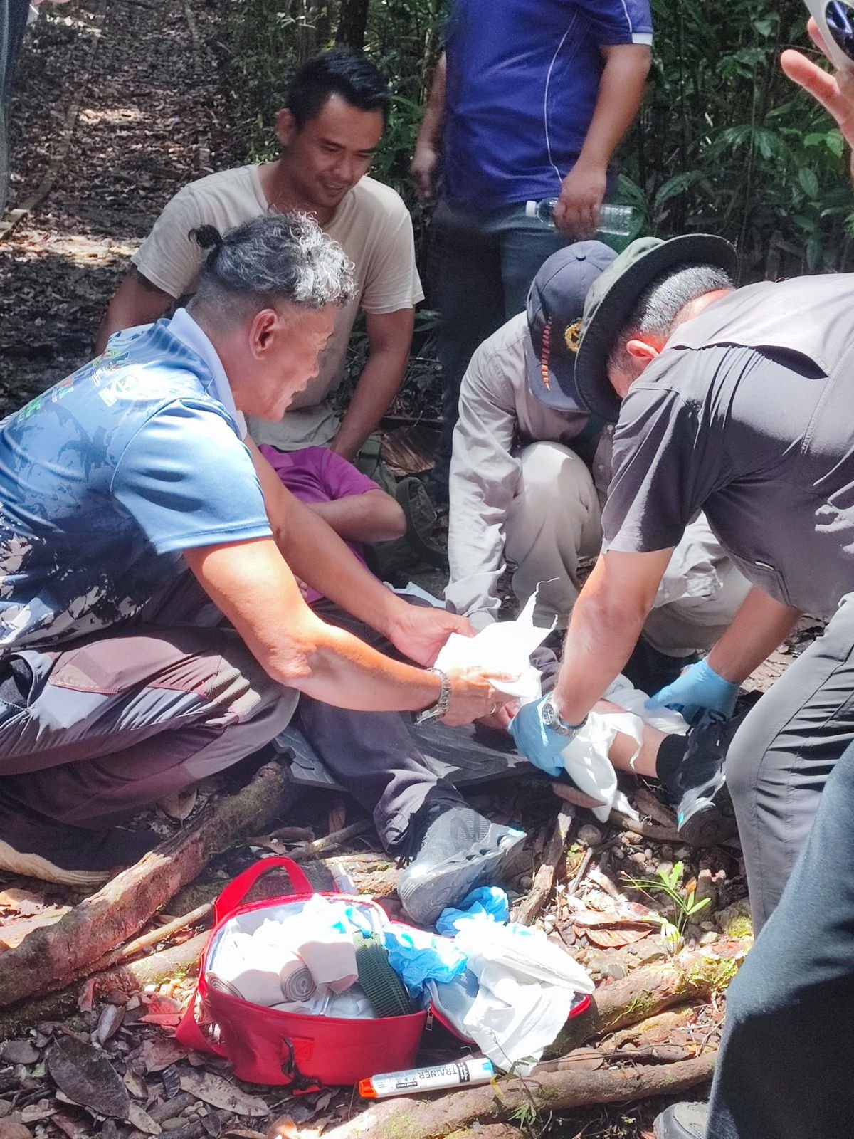 Realistic outdoor jungle scenario simulation with trainees treating a casualty